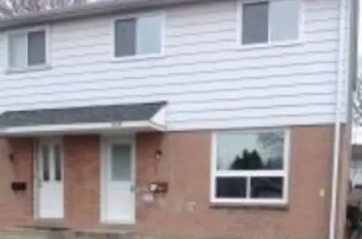 Cardiff Acres - townhouse with brown bricks and white siding