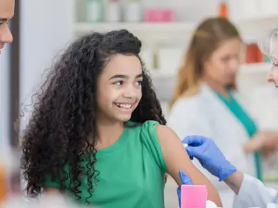 Young-woman-receives-a-vaccine-from-a-pharmacist.png