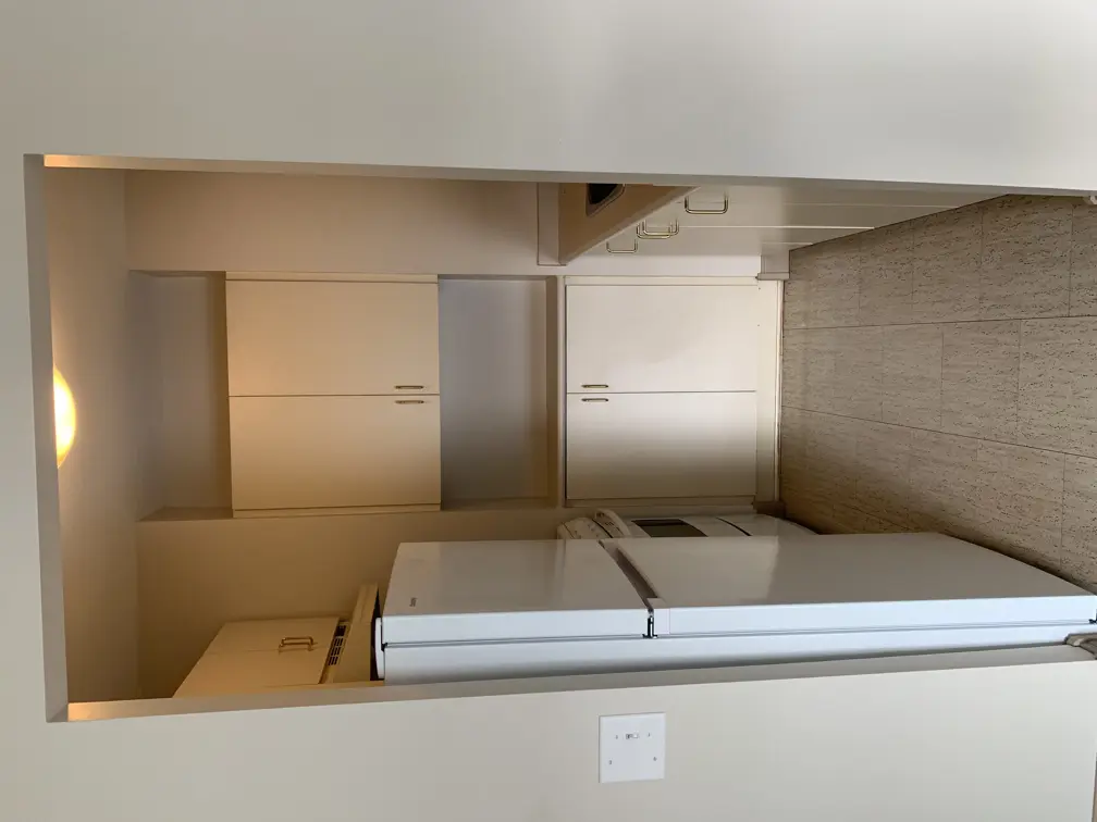 fridge, cabinets and stove set back into a kitchen area