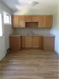 Spacious kitchen with cabinets and sink