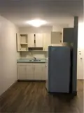 Cabinets and fridge in kitchen area