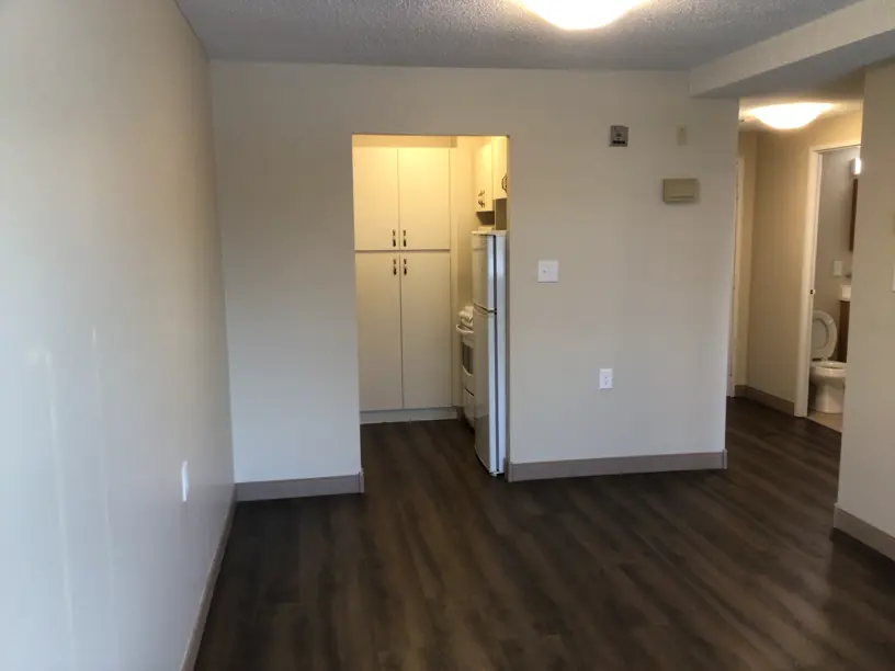 Looking into kitchen area and hallway from living room
