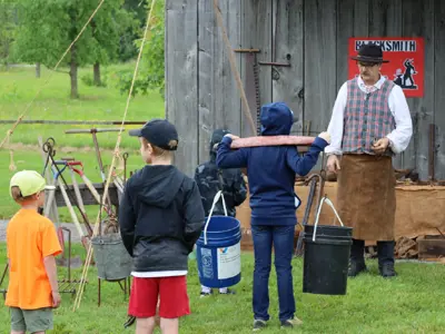 Visitors-participate-in-a-historical-blacksmithing-demonstration-at-Black-Gold-Fest-in-2023-web.png
