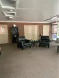 Chairs and side table in carpeted lounge