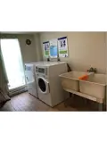 Washer and dryer in Alvinston Apartments laundry room