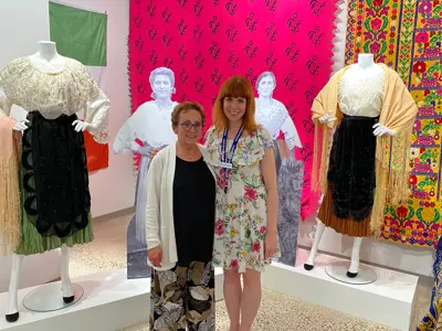 LHM-CuratorSupervisor-Dana-Thorne-and-exhibit-contributor-Antonia-Ambrose-stand-next-to-Italian-dresses.jpg