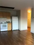 Stove, cabinets and fridge in kitchen area