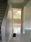 stairs and hallway leading to bright window