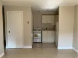 Stove, cabinets and fridge in kitchen area