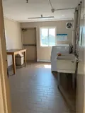 Table, washer, dryer and wash basin in laundry room