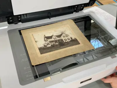 Archives-staff-scannig-a-historic-image-of-a-house---web.png
