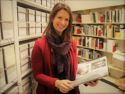 Archivist-Nicole-Aszalos-holds-photos-in-collections-storage-at-Lambton-County-Archives-web-01.png