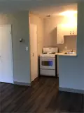 Stove with cabinets and sink in kitchen area
