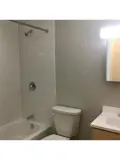 Shower/tub combo, toilet and sink in bathroom