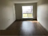 Spacious living room with large window