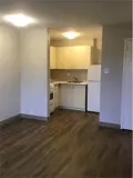 Stove, cabinets and fridge in kitchen area
