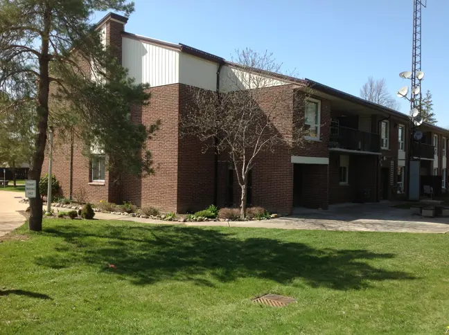 Brick apartment building with grassy lawn