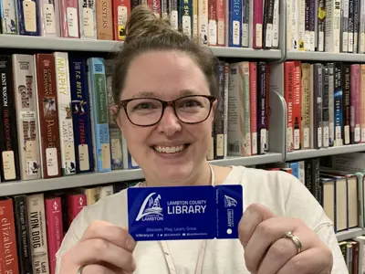 Staff-at-Lambton-County-Library-show-off-newly-designed-library-cards-web.jpg