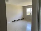 baseboard heater and window in bright living room
