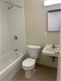 Shower/tub combo, toilet and sink in bathroom