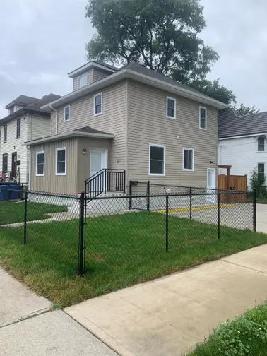 exterior of home with black chainlink fence around yard