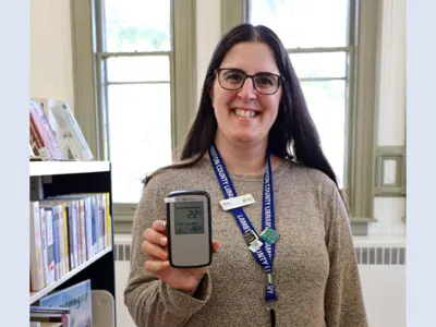 Branch-Assistant-Vivien-Szigyarto-demonstrates-the-new-Radon-Initial-Screening-Kit-web.png