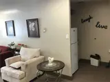 Chair, table and fridge in lounge