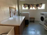 Wash basin, counter top, washer and dryer in laundry room
