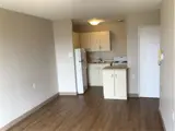 Kitchen area with fridge, sink and stove