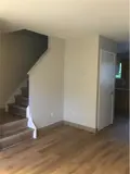 Living room area with stairs leading to second floor