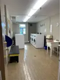 washing machines, dryers and wash basin in laundry room