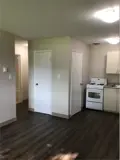 Closet, stove and cabinets in kitchen